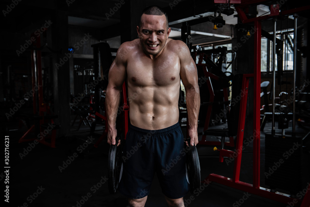 Portrait of asian man big muscle at the gym,Thailand people,Workout for good healthy,Body weight training,Fitness at the gym concept,Prank to abdominal muscles,Lift up heavy steel plate Portrait of asian man big muscle at the gym,Thailand people,Workout for good healthy,Body weight training,Fitness at the gym concept,Prank to abdominal muscles,Lift up heavy steel plate