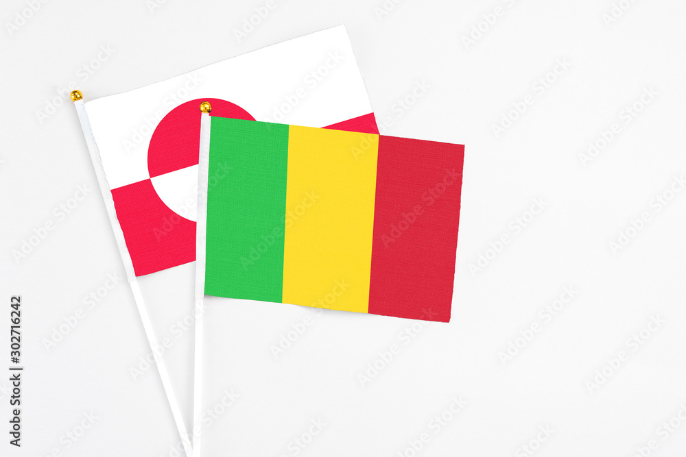 Mali and Greenland stick flags on white background. High quality fabric, miniature national flag. Peaceful global concept.White floor for copy space. Mali and Greenland stick flags on white background. High quality fabric, miniature national flag. Peaceful global concept.White floor for copy space.