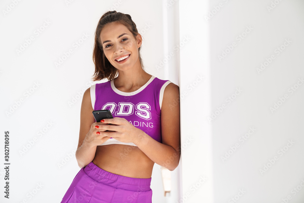 Happy cheerleader woman using mobile phone chatting. Happy cheerleader woman using mobile phone chatting.
