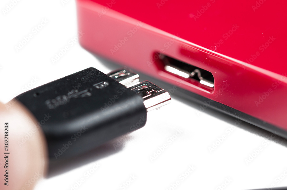 Red external hard with cable isolated on white background.Copy space Red external hard with cable isolated on white background.Copy space