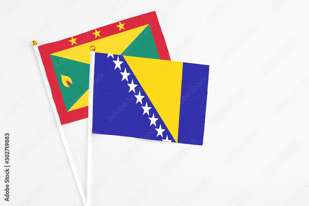 Bosnia Herzegovina and Grenada stick flags on white background. High quality fabric, miniature national flag. Peaceful global concept.White floor for copy space. Bosnia Herzegovina and Grenada stick flags on white background. High quality fabric, miniature national flag. Peaceful global concept.White floor for copy space.