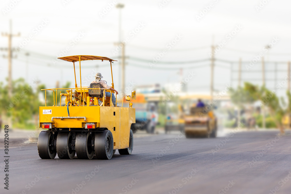 Driver control motor vehicle or heavy roller wheel tires or steamroller for road making or street - highway construction during working at work place Driver control motor vehicle or heavy roller wheel tires or steamroller for road making or street - highway construction during working at work place