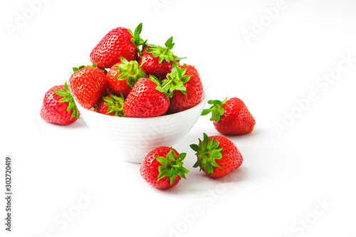 Red ripe strawberry in the white bowl  light background