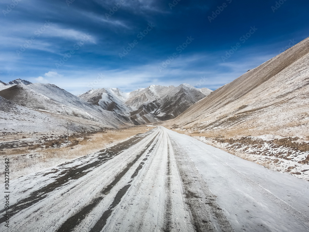 gravel road on snow mountain