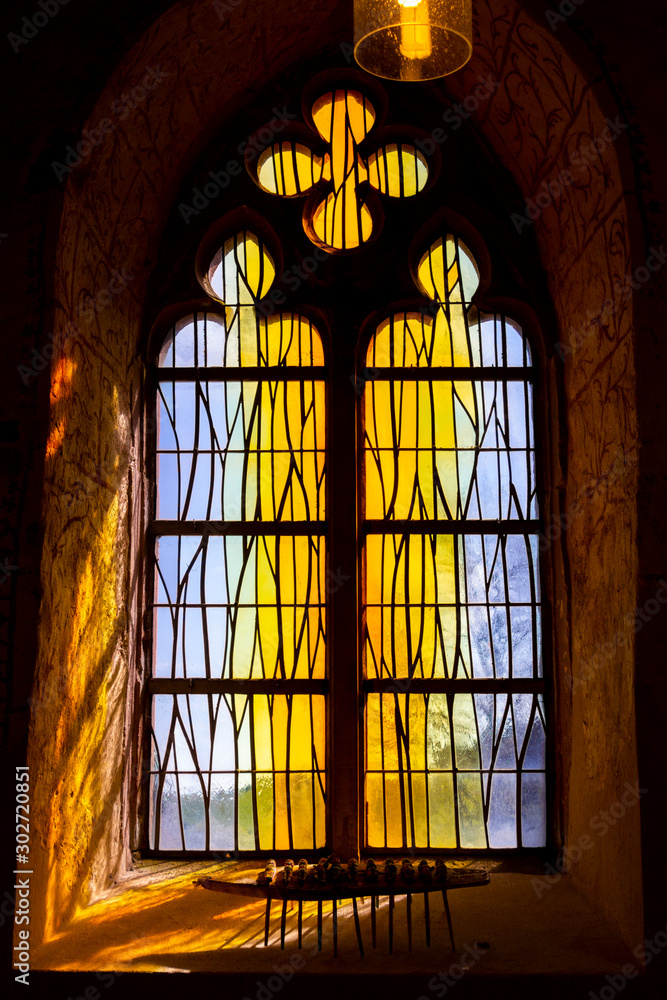 Beautiful stained glass window at the old Gothic Chapel of St. Eligius in Krewinkel, Belgium Beautiful stained glass window at the old Gothic Chapel of St. Eligius in Krewinkel, Belgium
