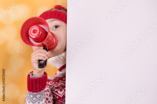 Little girl shouts something into the megaphone