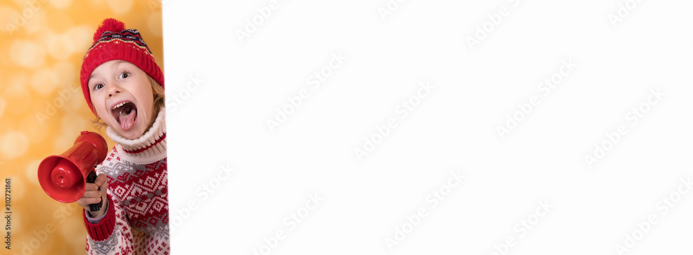 Fototapeta premium Little girl shouts something into the megaphone