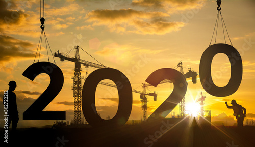 Silhouette construction site,Cranes building construction 2020 year sign