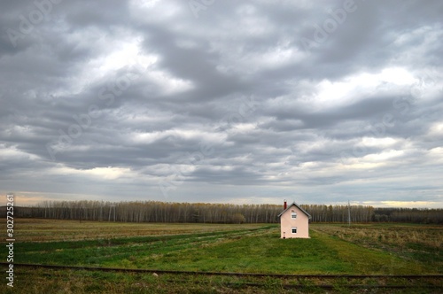 rain clouds and one house