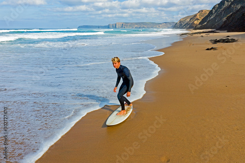 Canvas Print Aerial from a young surfer ready to surf at the atlantic ocean