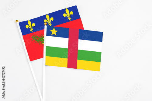 Central African Republic and Guadeloupe stick flags on white background. High quality fabric, miniature national flag. Peaceful global concept.White floor for copy space.