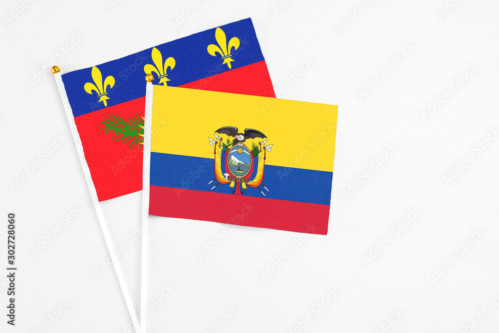 Ecuador and Guadeloupe stick flags on white background. High quality fabric, miniature national flag. Peaceful global concept.White floor for copy space. Ecuador and Guadeloupe stick flags on white background. High quality fabric, miniature national flag. Peaceful global concept.White floor for copy space.