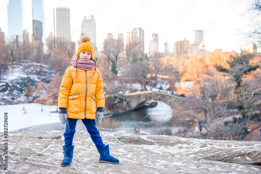 Adorable little girl with view of ice-rink in Central Park on Manhattan in New York City