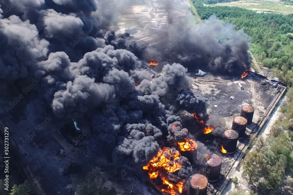 Oil storage fire. The tank farm is burning, black smoke is combu Oil storage fire. The tank farm is burning, black smoke is combu