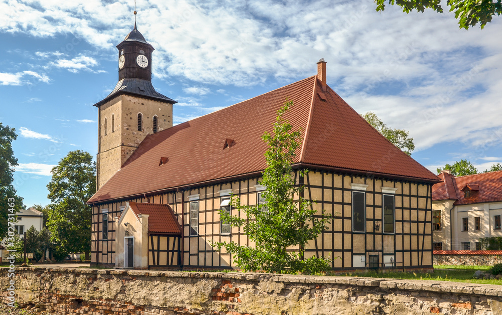 Church of Saint John the Baptist in Pisz from the 17th century (the oldest part - tower). The church, with half-timbered walls, was built in 1737. Masuria, Poland. 
