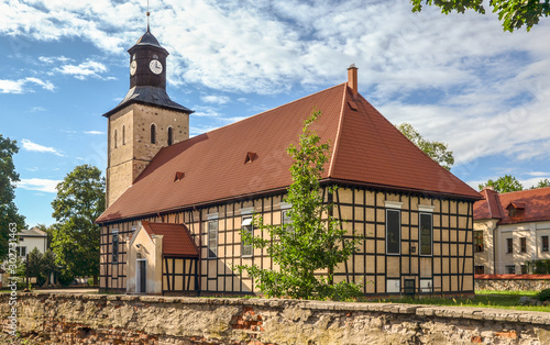 Church of Saint John the Baptist in Pisz from the 17th century (the oldest part - tower). The church, with half-timbered walls, was built in 1737. Masuria, Poland.  photo