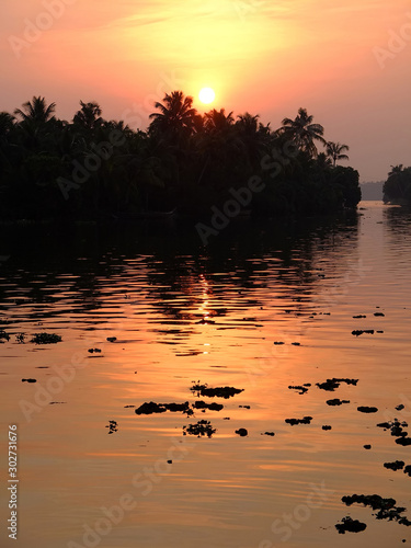 Sunset over lake in the backwaters of Kerala, India. photo