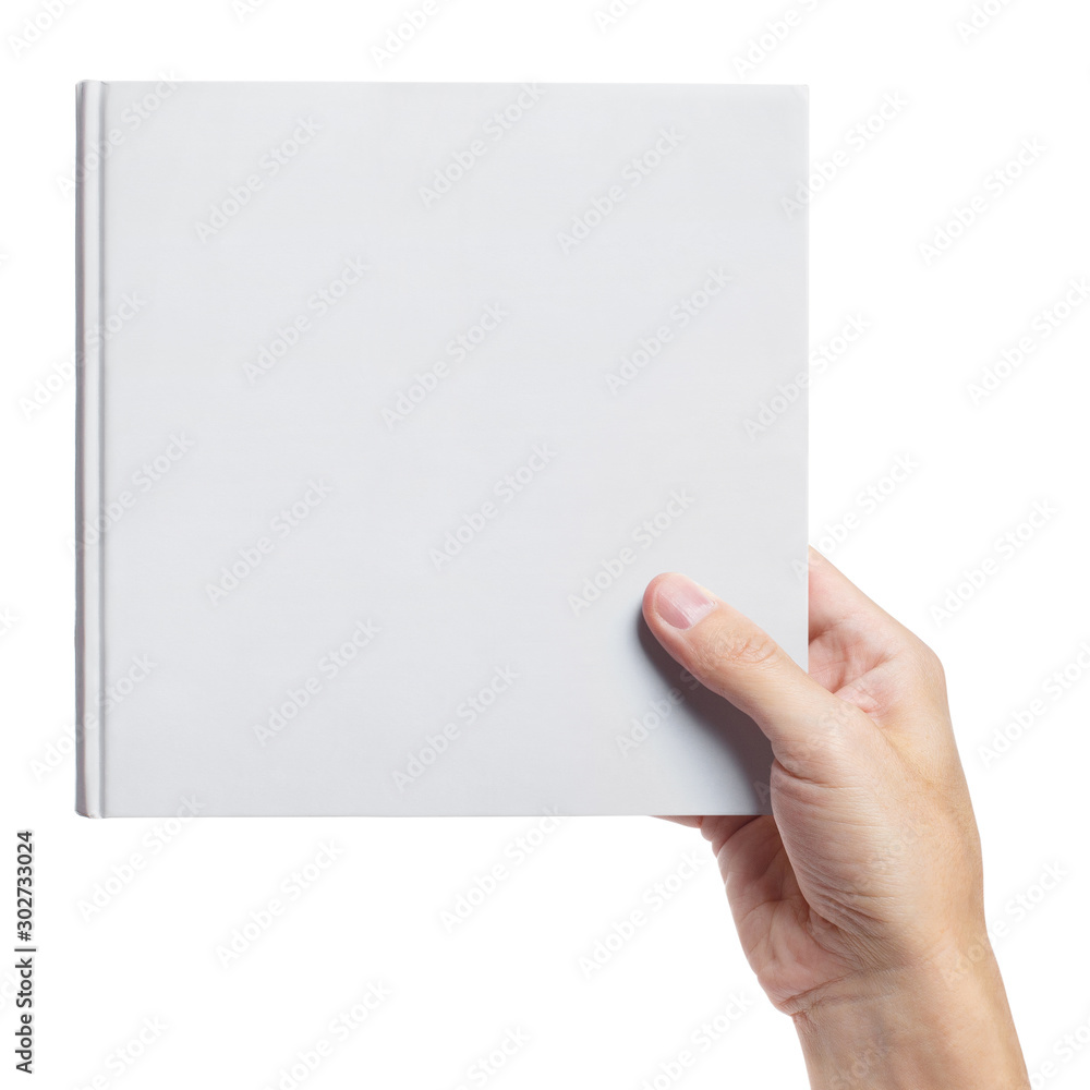 Obraz premium Hand holding a blank hard cover square book, isolated on white background