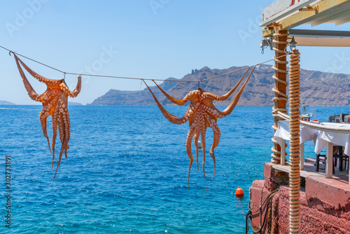 Octopus hanging outside restaurant by the sea, at Ammoudi Bay on Santorini
