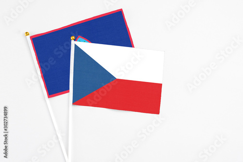 Czech Republic and Guam stick flags on white background. High quality fabric, miniature national flag. Peaceful global concept.White floor for copy space.