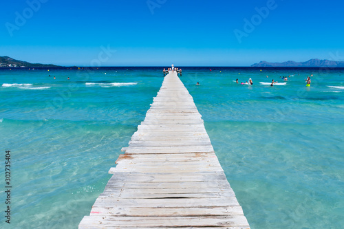 wooden pier on the shore of the Mediterranean sea in Alcudia in Mallorca © KVN1777