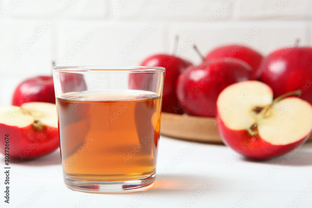 apple juice from red apples on the table. apple juice from red apples on the table.