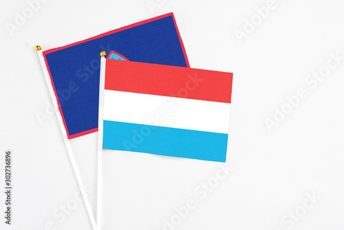 Free Download Luxembourg and Guam stick flags on white background. High quality fabric, miniature national flag. Peaceful global concept.White floor for copy space. - GFXLoad