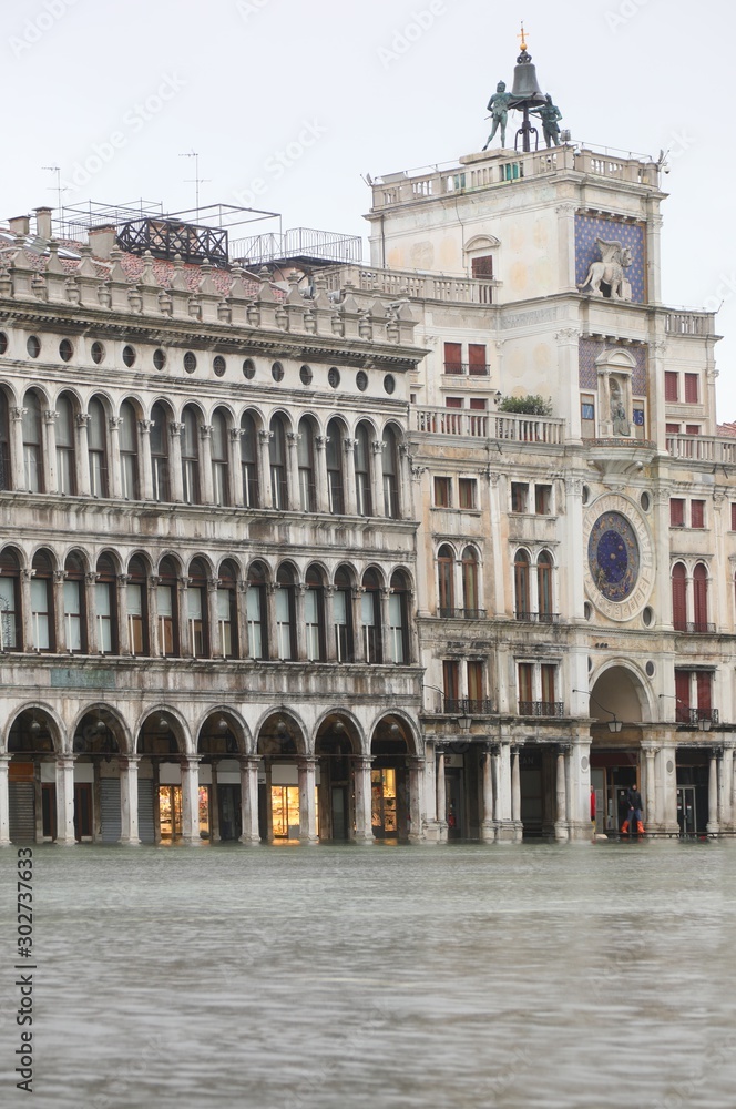 Ancient Clock Tower in Venice in Italy during the high tide