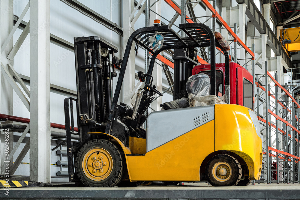 Compact forklift truck in a industrial warehouse building