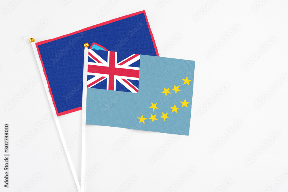 Tuvalu and Guam stick flags on white background. High quality fabric, miniature national flag. Peaceful global concept.White floor for copy space. Tuvalu and Guam stick flags on white background. High quality fabric, miniature national flag. Peaceful global concept.White floor for copy space.
