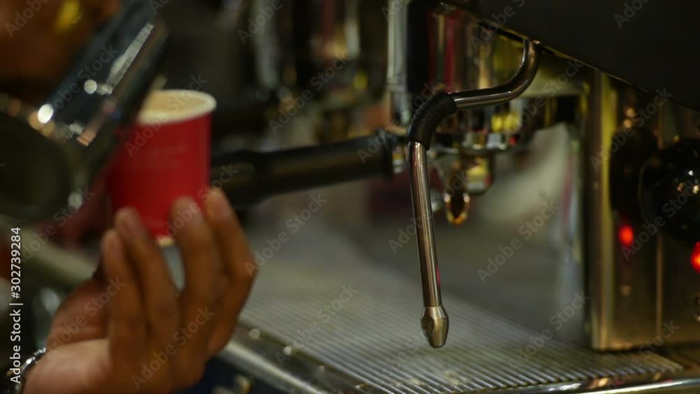 The coffee maker is put cup to machine for wait coffee liquid in coffeeshop. when start of work or workout is relax time for drink hot coffee . It can make fresh and power of life. The coffee maker is put cup to machine for wait coffee liquid in coffeeshop. when start of work or workout is relax time for drink hot coffee . It can make fresh and power of life.