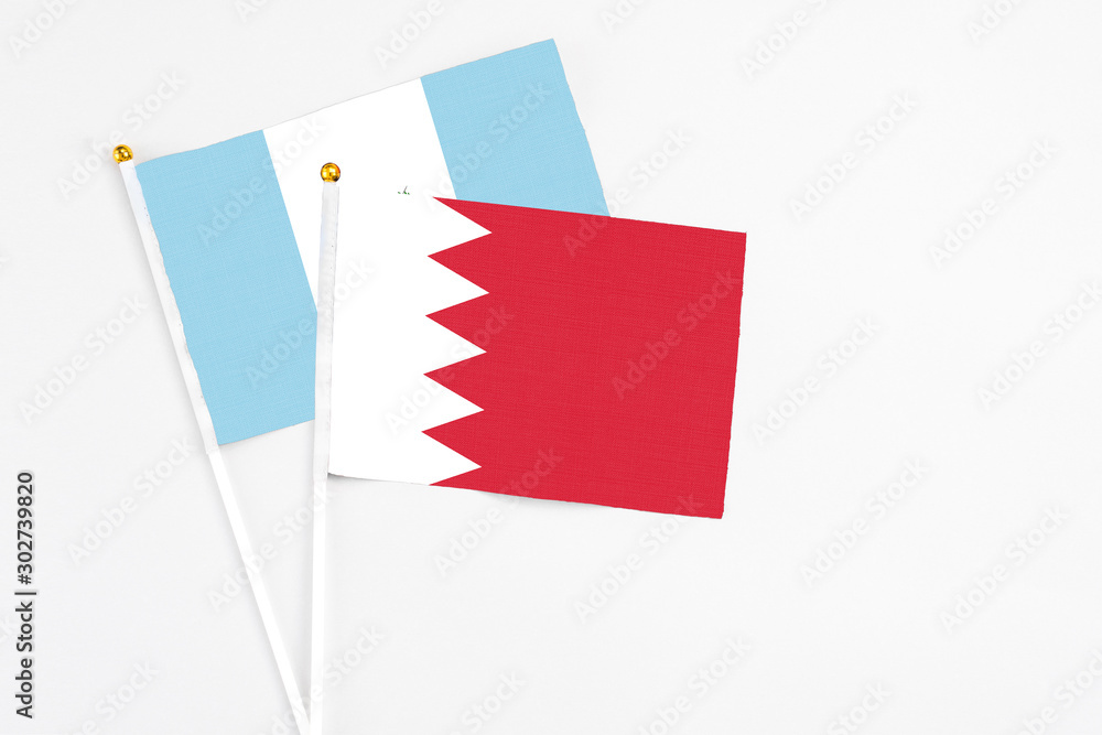 Bahrain and Guatemala stick flags on white background. High quality fabric, miniature national flag. Peaceful global concept.White floor for copy space. Bahrain and Guatemala stick flags on white background. High quality fabric, miniature national flag. Peaceful global concept.White floor for copy space.