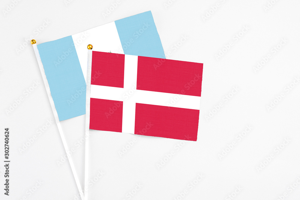 Denmark and Guatemala stick flags on white background. High quality fabric, miniature national flag. Peaceful global concept.White floor for copy space.