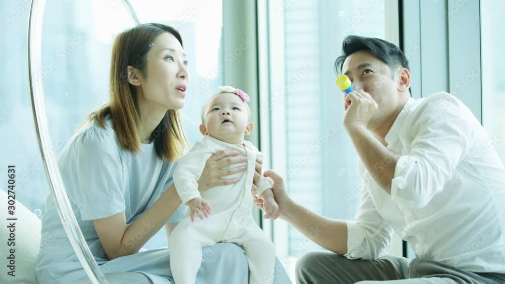 Adorable Chinese baby daughter enjoying relaxing soap bubbles Adorable Chinese baby daughter enjoying relaxing soap bubbles