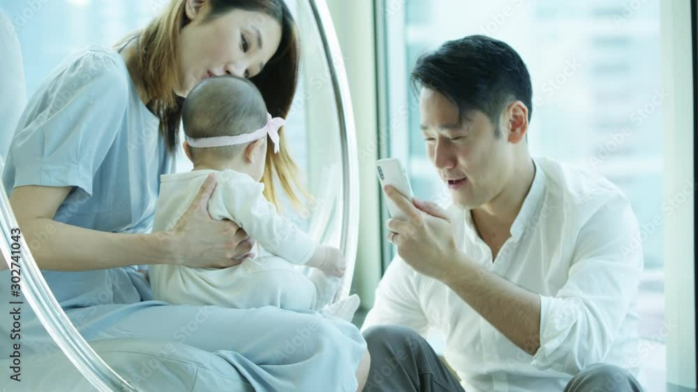 Chinese Asian mother father baby taking smartphone photos Chinese Asian mother father baby taking smartphone photos