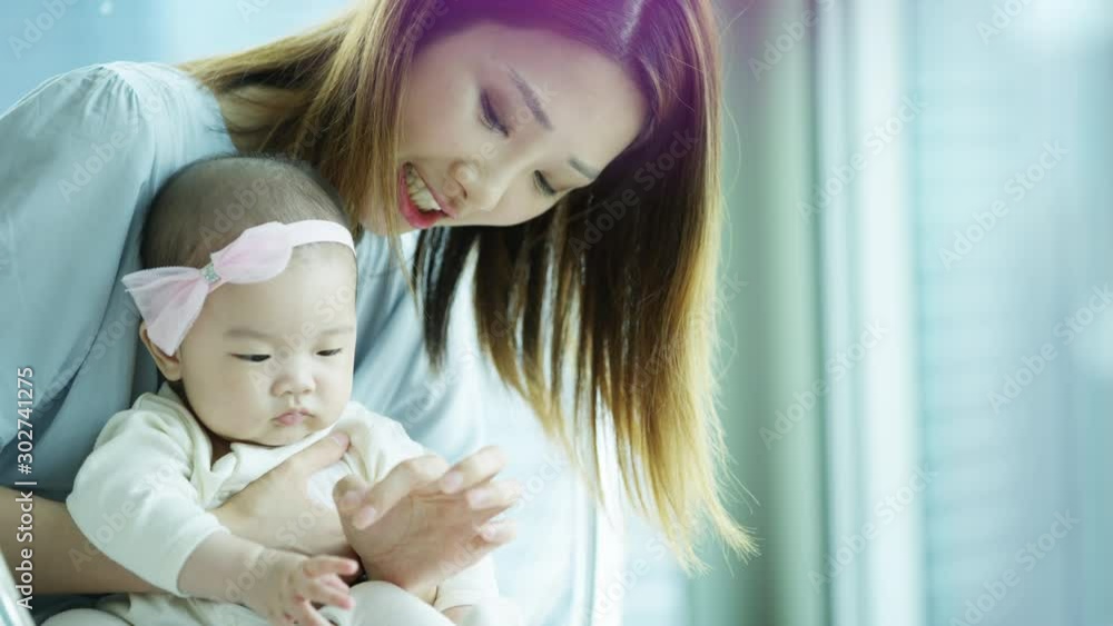 Chinese mum baby playing quietly together swing pod Chinese mum baby playing quietly together swing pod