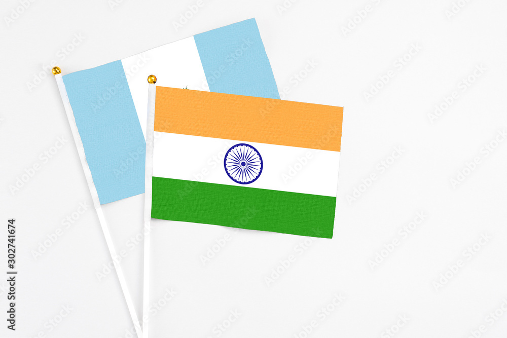 India and Guatemala stick flags on white background. High quality fabric, miniature national flag. Peaceful global concept.White floor for copy space. India and Guatemala stick flags on white background. High quality fabric, miniature national flag. Peaceful global concept.White floor for copy space.