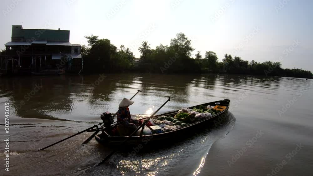 Sunrise trader cruising up the Mekong river Vietnam Sunrise trader cruising up the Mekong river Vietnam
