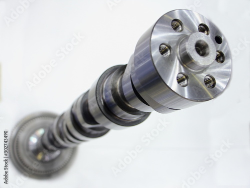 New car motor camshaft in perspective on white background close up photo