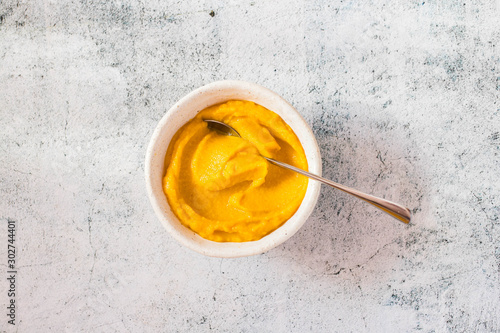 Yellow pumpkin puree with fresh vegetables.