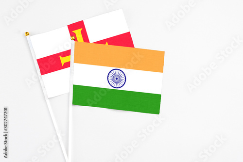 Free Download India and Guernsey stick flags on white background. High quality fabric, miniature national flag. Peaceful global concept.White floor for copy space. - GFXLoad