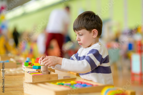 Cute Little Boy Playing at Kindergarten with Construction Toy