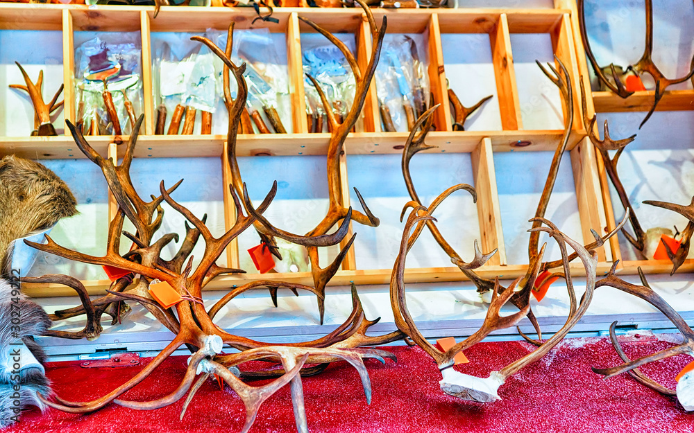 Market stall with traditional souvenirs such as reindeer horns at winter Rovaniemi, Lapland, Finland. Street Xmas holiday fair. Advent Decoration and Stalls with Crafts Items on Bazaar Market stall with traditional souvenirs such as reindeer horns at winter Rovaniemi, Lapland, Finland. Street Xmas holiday fair. Advent Decoration and Stalls with Crafts Items on Bazaar