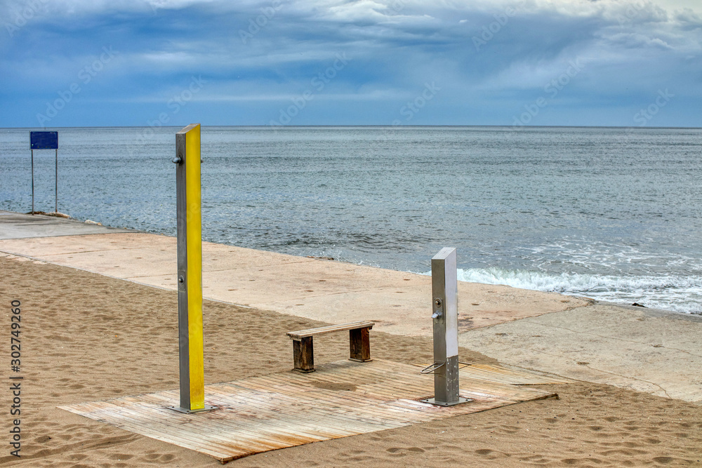 Shower on the beach to clean the sand and salt after bathing Shower on the beach to clean the sand and salt after bathing