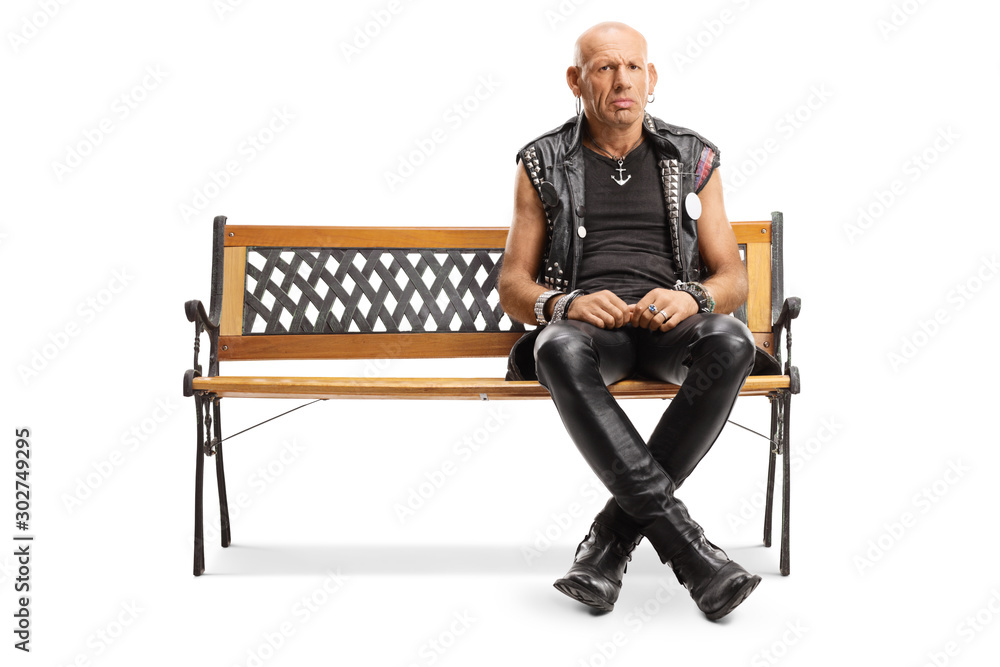 Serious punker sitting on a bench