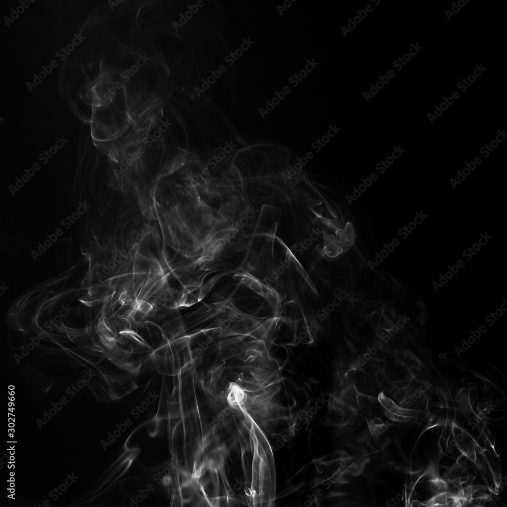 Gray smoke on a black background. Realistic incense smoke captured with a flash. Gray smoke on a black background. Realistic incense smoke captured with a flash.