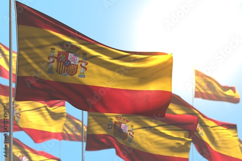 wonderful any feast flag 3d illustration. - many Spain flags are waving against blue sky illustration with selective focus