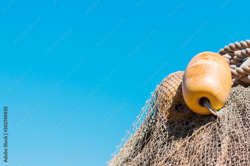 Fishing nets with buoy and rope. Marine background. Nautical photo.