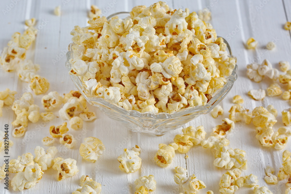 Salt popcorn on the wooden table, selective focus. Horizontal. Copy space. Salt popcorn on the wooden table, selective focus. Horizontal. Copy space.