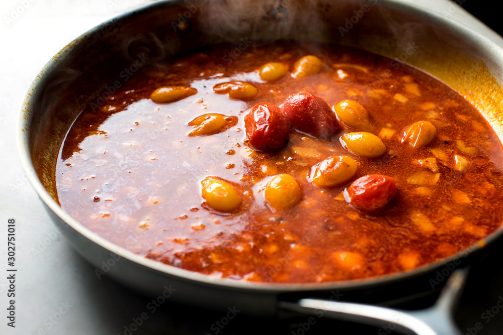 Prawn and tomato stock on frying pan Prawn and tomato stock on frying pan
